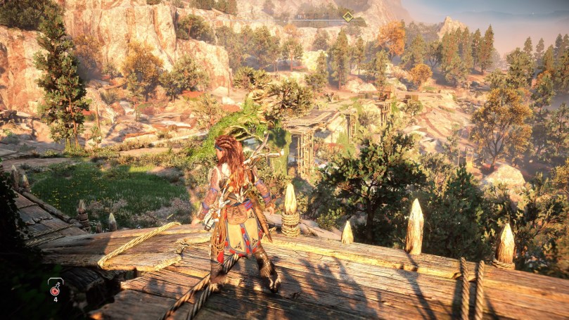 Aloy standing on a scaffold overlooking a lightly wooded area in front of a guarded rebel camp.