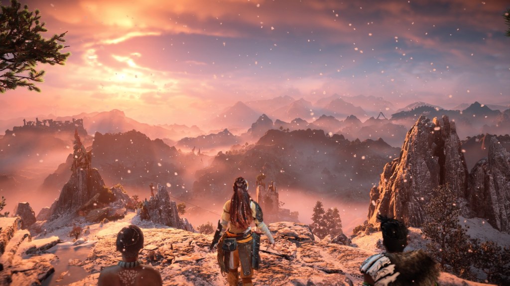 Aloy and her friends overlooking the mountains of the Forbidden West from a base high in the mountains.