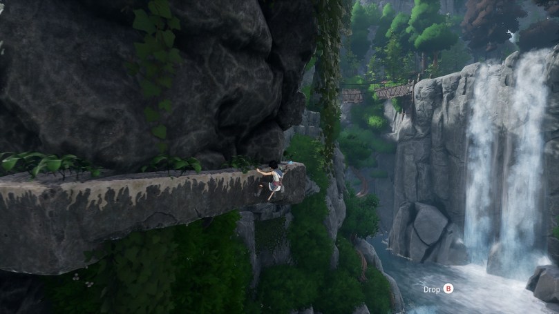 Kena clambering on the walls of a large stone formation in the midst of a sea. There is a waterfall in the background.