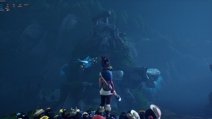 Kena looking at a rock formation in the dark that serves as a 3D platforming puzzle with several floating platforms.