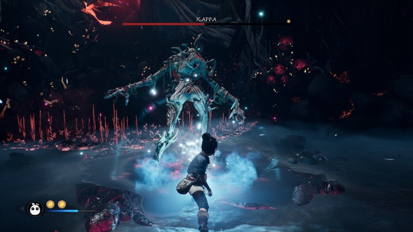 Kena in a battle with a large wooden boss creature in a dark cave.