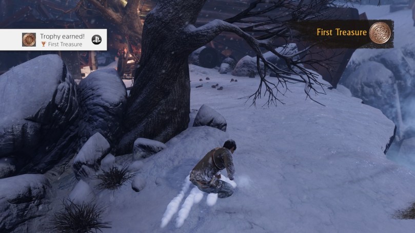 Nate finding his first collectible treasure next to a tree in the snow.