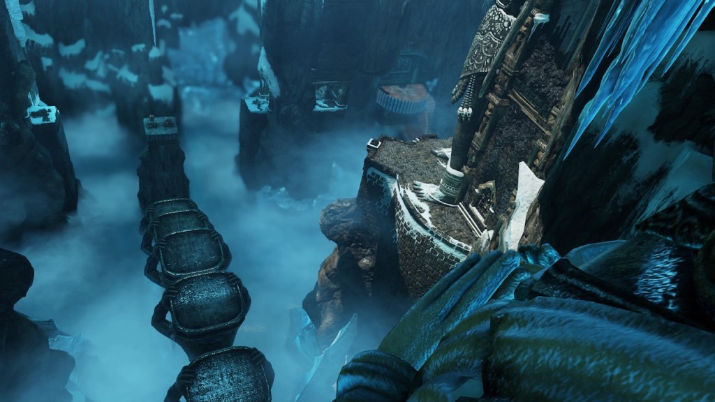 View into an icy tomb from a high position revealing several pillars as platforms and an abyss.
