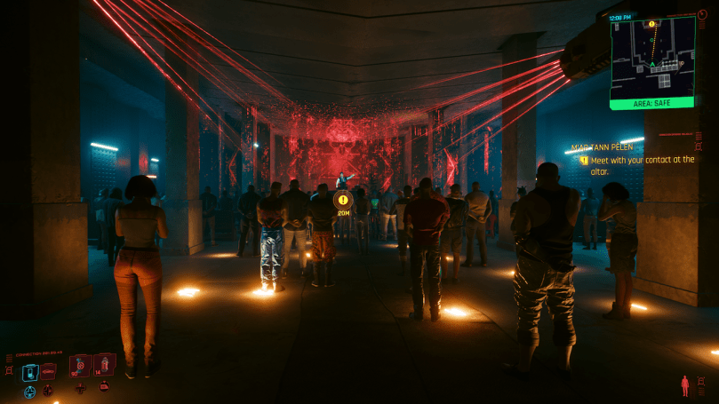 A screenshot of Cyberpunk 2077 showing the inside of a large room with a crowd of people listening to someone speak onstage.