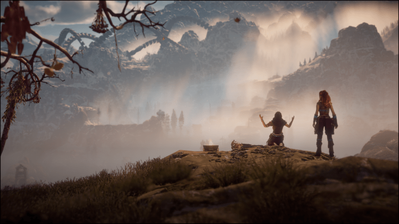 A screenshot of Horizon Zero Dawn, showing Aloy on a ridge and mountains in the background.