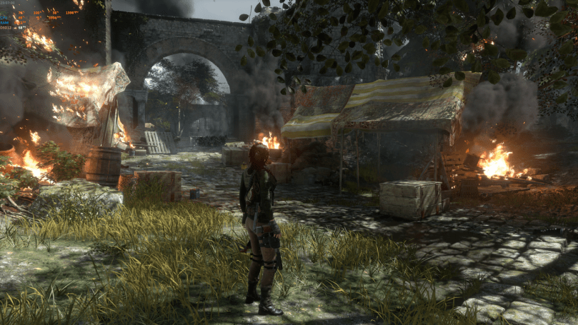 A screenshot of Rise of the Tomb Raider showing Lara late in the game in castle ruins with a camp on fire.