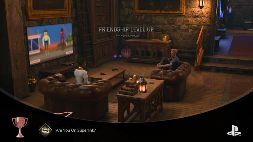 The Hunter and Captain Marvel leveling up their friendship watching TV in the Abbey common room.