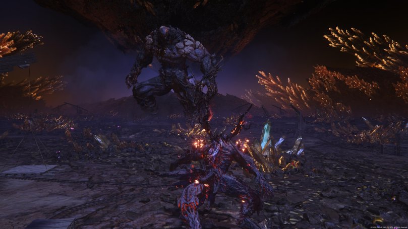 The Eikons Titan and Ifrit opposing each other in a dark and cave-like arena for an Eikon battle. Titan is about three times the size of Clive's Ifrit.