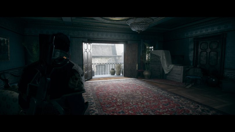 The protagonist standing in a carpeted room looking toward the open doors to the balcony, which is the only light source illuminating the room, giving it a somber atmosphere.