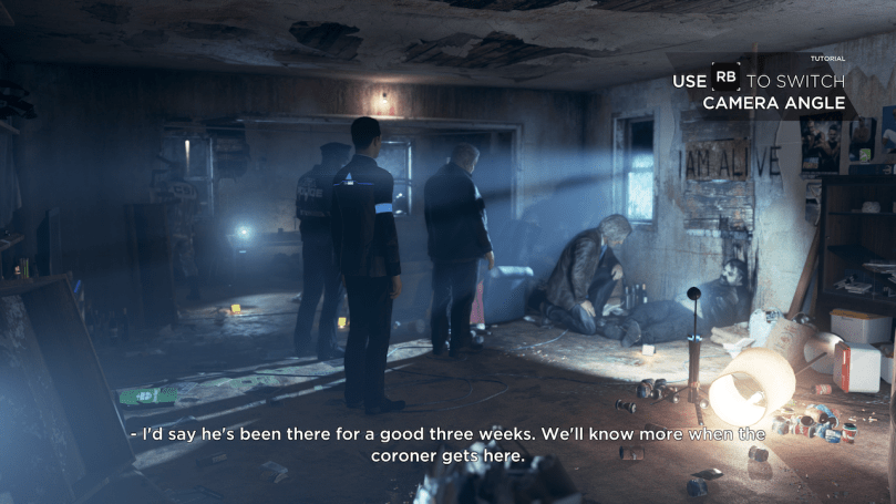 A violent crime scene in a run down building shows a police detective kneeling next to the victim, two officers and an android looking and talking to the detective.