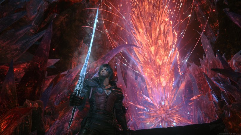Clive standins in front of a red-orange mothercristal in a dark cavern with a long ice-colored sword in his right hand facing away from the crystal.