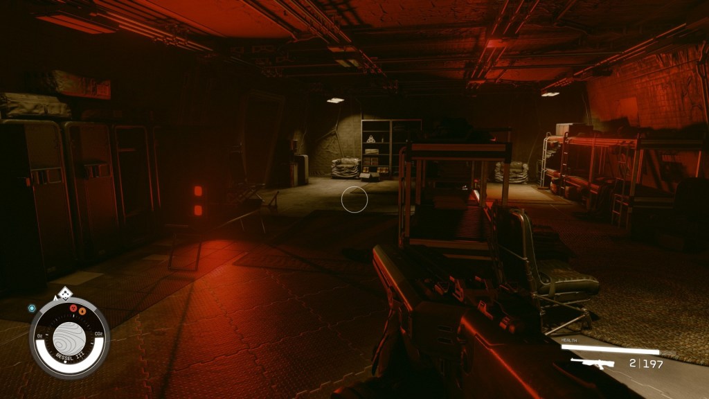 A dark bunker illuminated in dark red emergency lights.