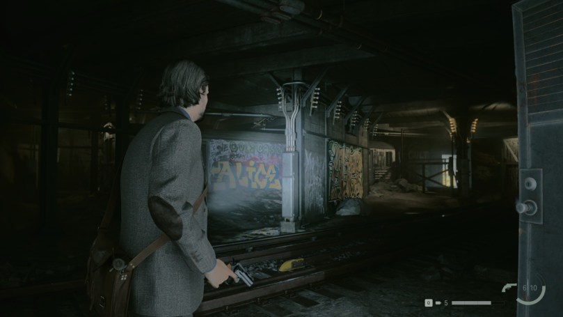 Alan Wake is in the dark subway tunnels of New York with a flashlight in his left and a revolver in his right hand.