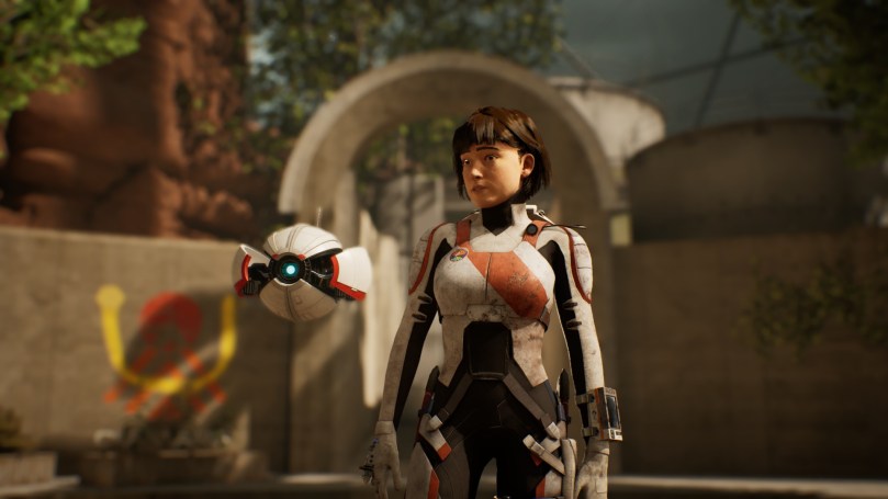 The main character of Deliver Us Mars and her drone are in the foreground of an in-game cutscene where they enter a new settlement on Mars.